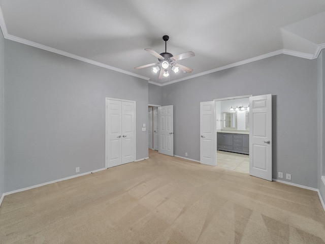 unfurnished bedroom with baseboards, ornamental molding, and light carpet