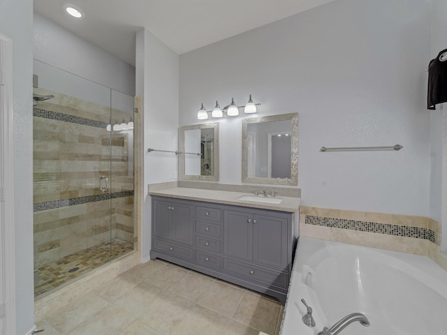 bathroom with tile patterned flooring, a shower stall, a bath, and vanity