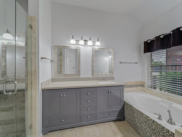 bathroom with vaulted ceiling, a shower stall, a bath, and vanity