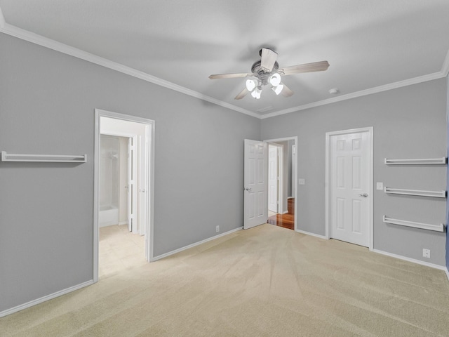 unfurnished bedroom featuring carpet flooring, baseboards, ornamental molding, and connected bathroom