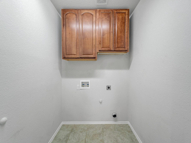laundry room with gas dryer hookup, washer hookup, electric dryer hookup, cabinet space, and baseboards