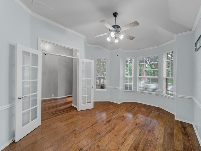 unfurnished room with ceiling fan, french doors, visible vents, wood finished floors, and ornamental molding