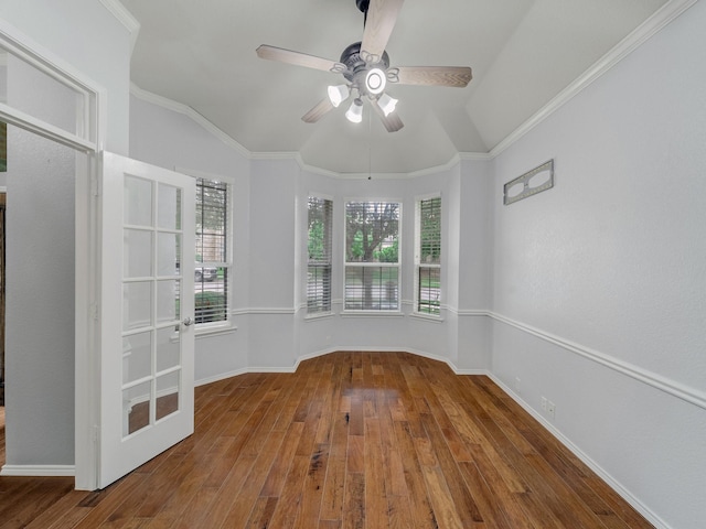 empty room featuring vaulted ceiling, baseboards, a ceiling fan, and hardwood / wood-style floors