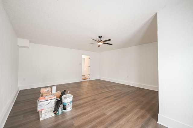 interior space featuring baseboards, ceiling fan, and wood finished floors