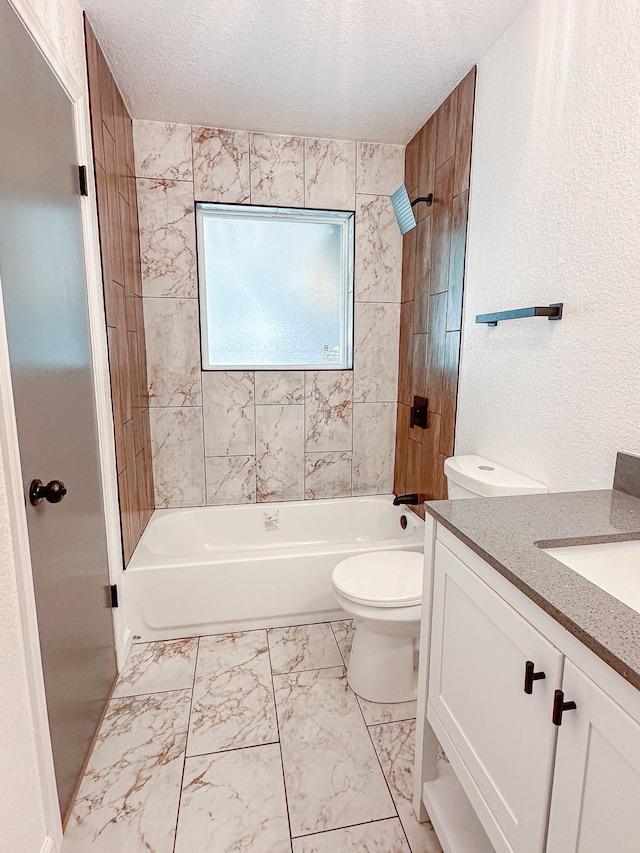 full bathroom featuring vanity, bathtub / shower combination, toilet, and a textured ceiling