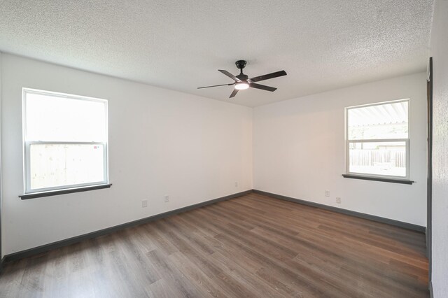 8511 Strathmore Dr, Dallas, TX 75238 - unfurnished room with wood finished floors, ceiling fan, baseboards, and a textured ceiling