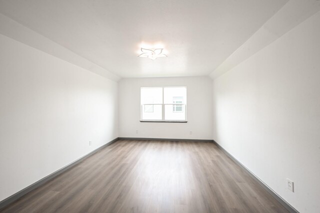 8511 Strathmore Dr, Dallas, TX 75238 - spare room featuring wood finished floors and baseboards