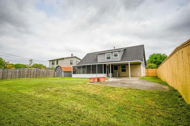 8511 Strathmore Dr, Dallas, TX 75238 - back of house with a sunroom, a patio, a storage unit, a shingled roof, and an outdoor structure