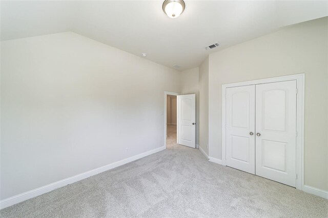 341 Gleneagles Dr, Garland, TX 75040 - unfurnished bedroom featuring baseboards, carpet, a closet, and lofted ceiling