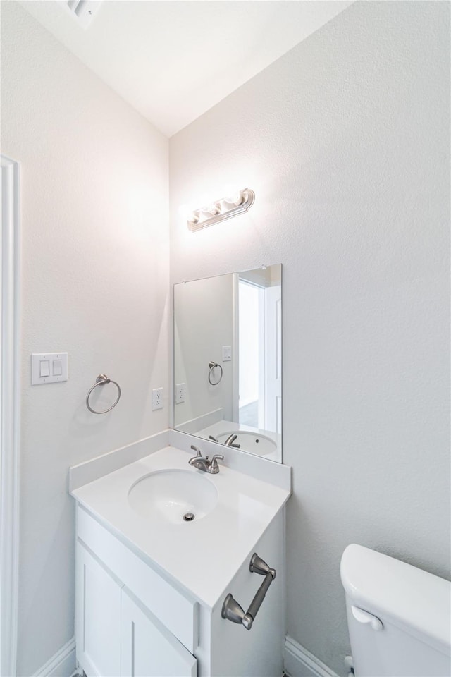 341 Gleneagles Dr, Garland, TX 75040 - half bathroom with vanity, baseboards, and toilet
