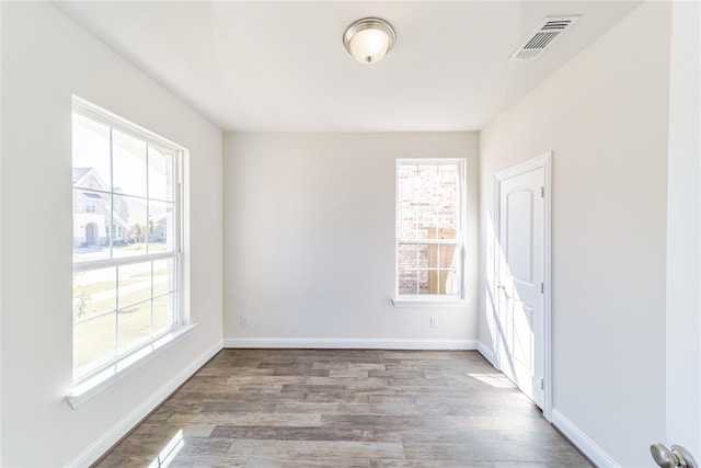 341 Gleneagles Dr, Garland, TX 75040 - empty room with visible vents, plenty of natural light, and wood finished floors