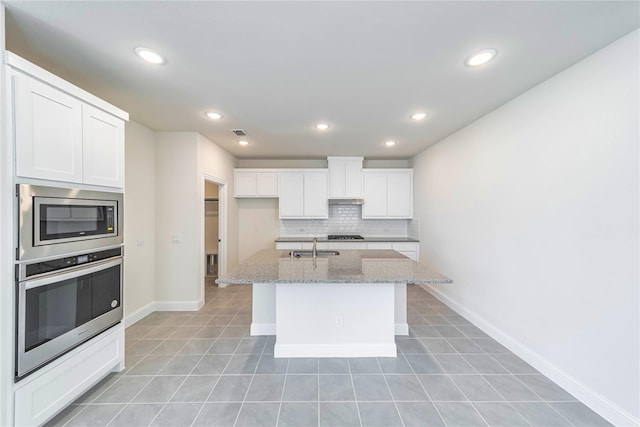 341 Gleneagles Dr, Garland, TX 75040 - kitchen featuring backsplash, a sink, light stone counters, stainless steel appliances, and recessed lighting