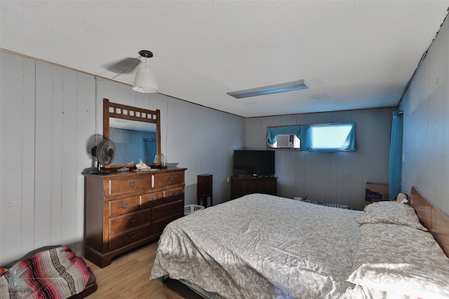 934 Burger St, Abilene, TX 79603 - bedroom with a textured ceiling, wood finished floors, and wooden walls