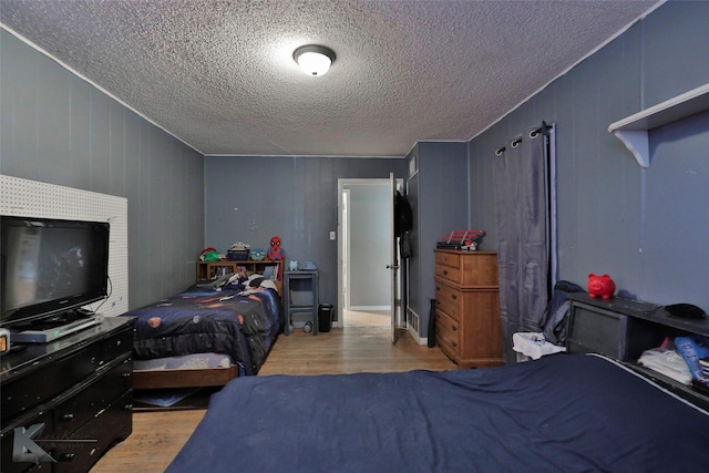 934 Burger St, Abilene, TX 79603 - bedroom with a textured ceiling and wood finished floors