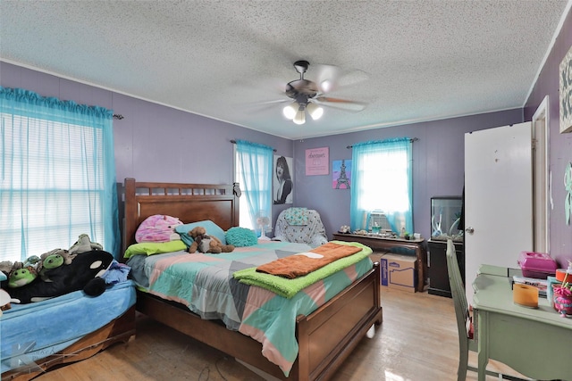 934 Burger St, Abilene, TX 79603 - bedroom with ceiling fan, light wood-type flooring, and a textured ceiling