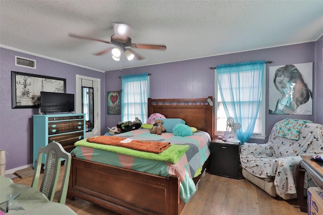 934 Burger St, Abilene, TX 79603 - bedroom featuring visible vents, a textured ceiling, wood finished floors, and multiple windows