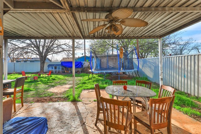 934 Burger St, Abilene, TX 79603 - view of patio / terrace with a fenced backyard, a ceiling fan, a trampoline, and outdoor dining space