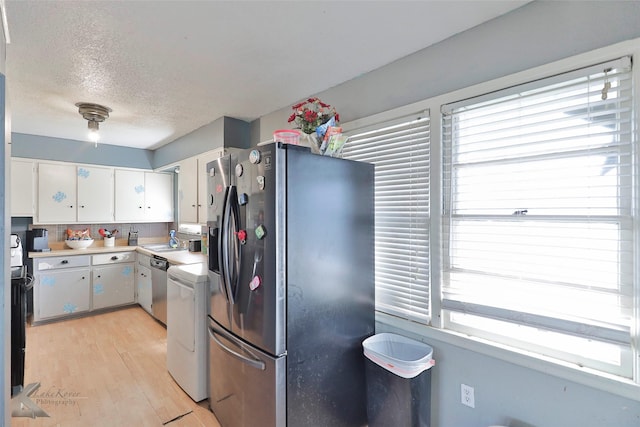 934 Burger St, Abilene, TX 79603 - kitchen featuring white cabinets, appliances with stainless steel finishes, a sink, light countertops, and a textured ceiling