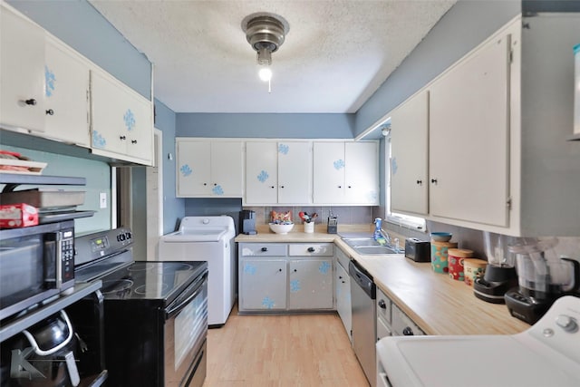 934 Burger St, Abilene, TX 79603 - kitchen featuring light countertops, stainless steel dishwasher, black electric range oven, and washer / clothes dryer