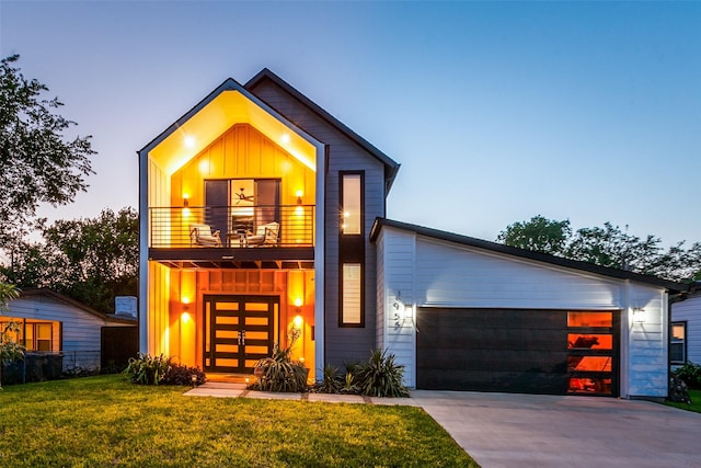 11955 Hoblitzelle Dr, Dallas, TX 75243 - modern home with board and batten siding, a balcony, a front lawn, driveway, and a garage