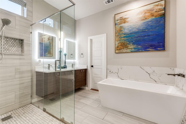 11955 Hoblitzelle Dr, Dallas, TX 75243 - bathroom with double vanity, a shower stall, and a freestanding bath