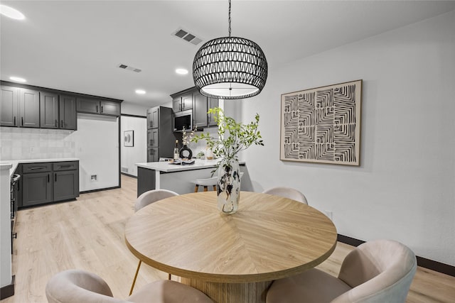 dining space featuring recessed lighting, baseboards, light wood finished floors, and visible vents