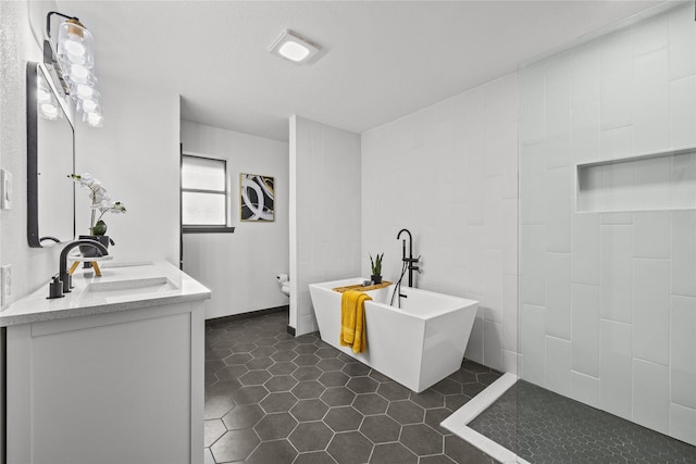 washroom featuring dark tile patterned floors and a sink
