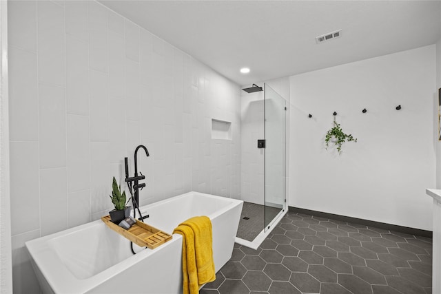 bathroom featuring tile patterned floors, recessed lighting, a freestanding tub, visible vents, and a stall shower