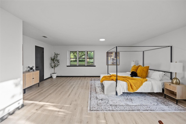 bedroom with baseboards, recessed lighting, wood finished floors, and visible vents