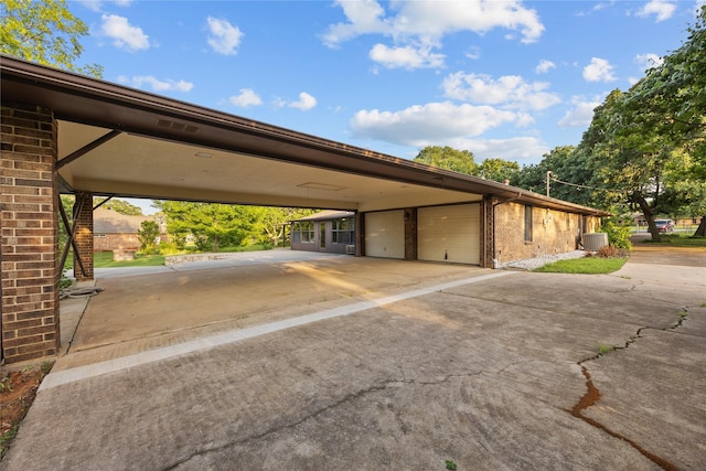 view of parking / parking lot featuring an attached garage and driveway