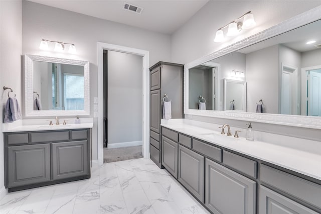 full bathroom featuring visible vents, two vanities, a sink, and marble finish floor