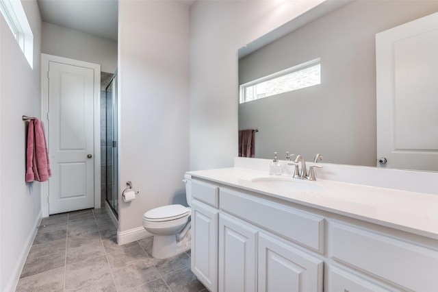 bathroom with tile patterned flooring, vanity, toilet, baseboards, and a shower stall