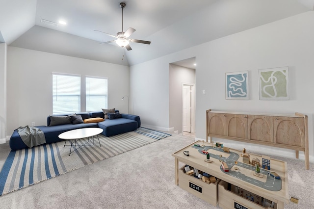 living room featuring baseboards, carpet, ceiling fan, and vaulted ceiling