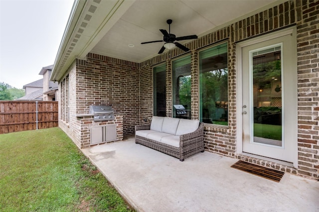 view of patio / terrace featuring grilling area, exterior kitchen, ceiling fan, and fence