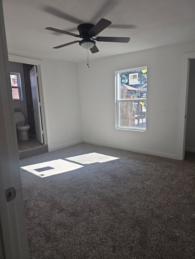 empty room featuring carpet floors and a ceiling fan