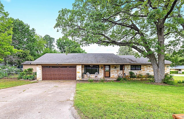1730 W Hull St, Denison, TX 75020 - single story home with fence, a front yard, stone siding, concrete driveway, and an attached garage