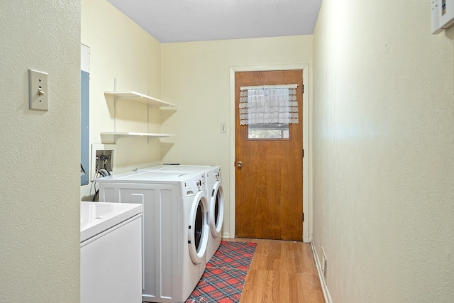 1730 W Hull St, Denison, TX 75020 - laundry area featuring laundry area, a textured wall, washing machine and dryer, and light wood-type flooring