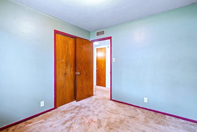 1730 W Hull St, Denison, TX 75020 - unfurnished bedroom with carpet floors, a closet, and visible vents