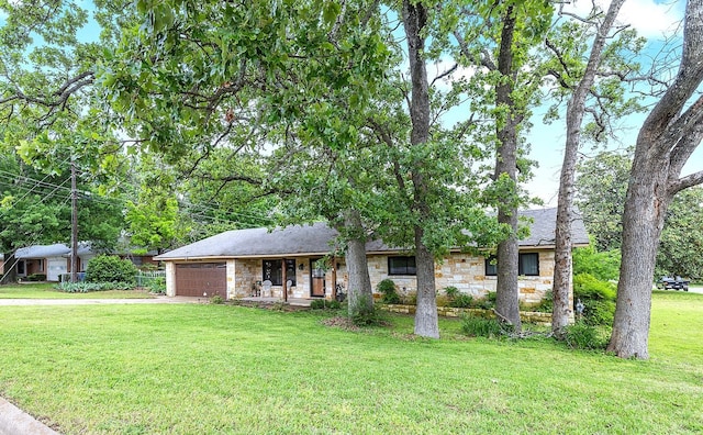 1730 W Hull St, Denison, TX 75020 - ranch-style home with a front yard, driveway, stone siding, and a garage
