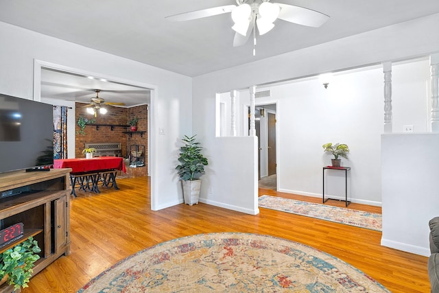 1730 W Hull St, Denison, TX 75020 - interior space with light wood-style floors, a brick fireplace, ceiling fan, and baseboards