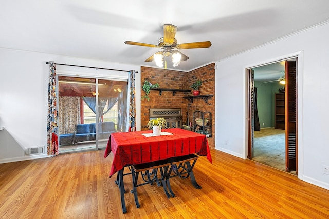 1730 W Hull St, Denison, TX 75020 - dining room with baseboards, a ceiling fan, wood finished floors, and a fireplace