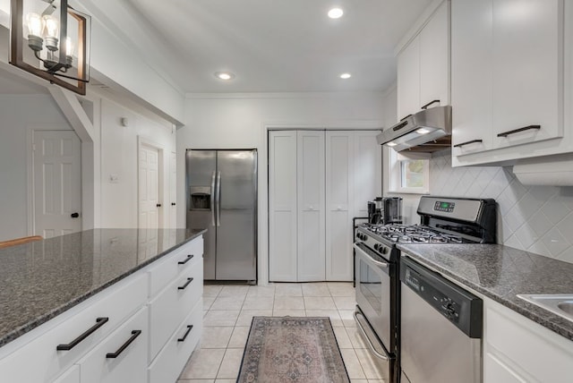 kitchen featuring tasteful backsplash, white cabinets, under cabinet range hood, stainless steel appliances, and light tile patterned flooring