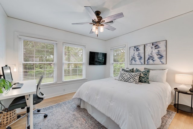 bedroom featuring baseboards and light wood-style floors