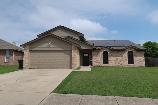 view of front of property featuring brick siding, an attached garage, driveway, and a front lawn