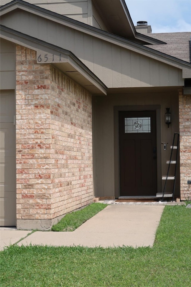 property entrance featuring brick siding