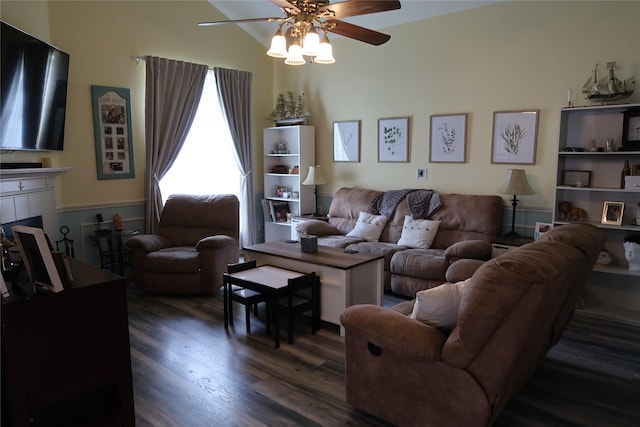 living area featuring a ceiling fan and dark wood finished floors