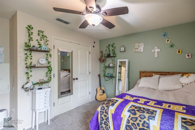 carpeted bedroom featuring a ceiling fan and visible vents