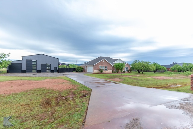 view of outdoor structure with driveway and an outbuilding