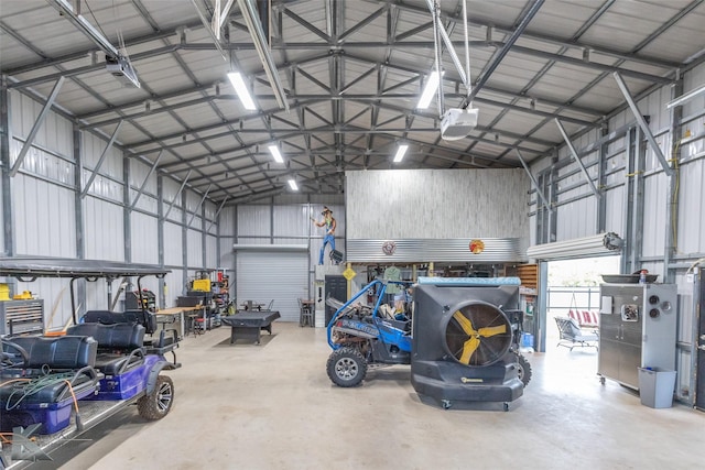 garage featuring a garage door opener and metal wall