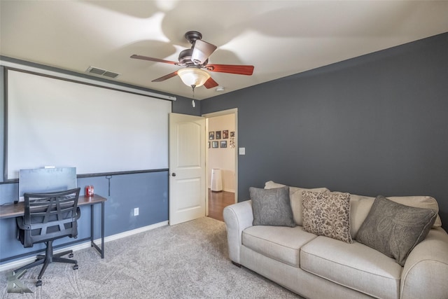 carpeted home office with baseboards, ceiling fan, and visible vents
